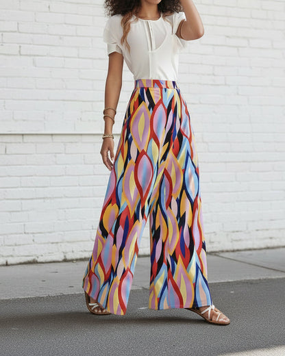 Pantalones acampanados Isabella Sol con estampado vibrante