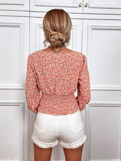 Elegante top floral de manga larga con escote en V de Isabella Sol.