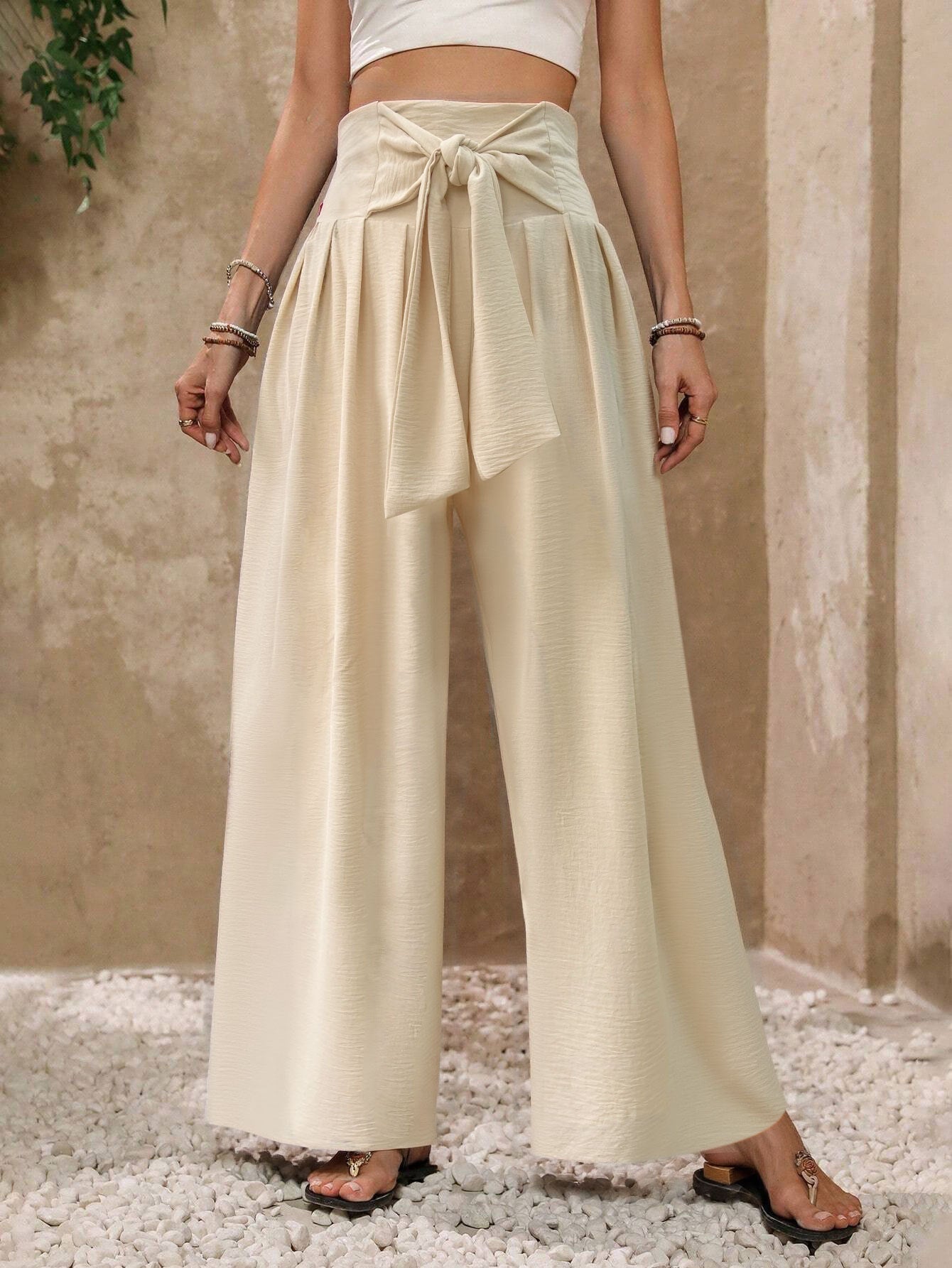 Pantalones casuales de mujer de talle alto, color liso, con lazo frontal y pernera ancha.